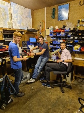 Three team members working in the rocket workshop